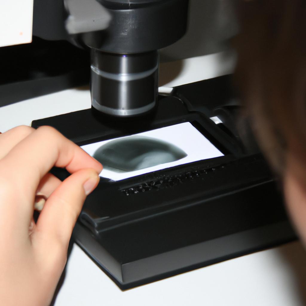 Person examining microscope slide, researching